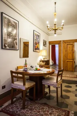 a dining room with a table and two chairs at La Dolce Vita Roma in Rome