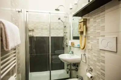 a bathroom with a glass shower and a sink at La Dolce Vita Roma in Rome