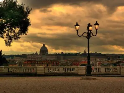 a street light with a view of a city at La Dolce Vita Roma in Rome