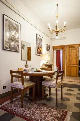 a dining room with a table and two chairs at La Dolce Vita Roma in Rome