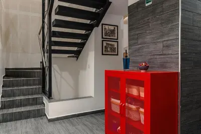 a red cabinet in a room with a staircase at Guesthouse Sant'Angelo in Rome