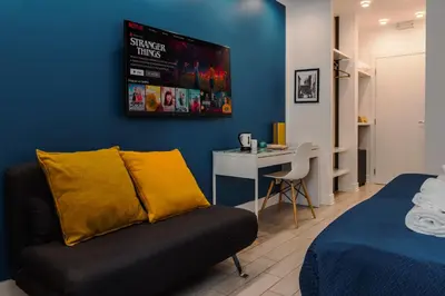 a bedroom with a couch and a desk in a room at Guesthouse Sant'Angelo in Rome