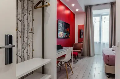 a room with red walls and a table and chairs at Guesthouse Sant'Angelo in Rome