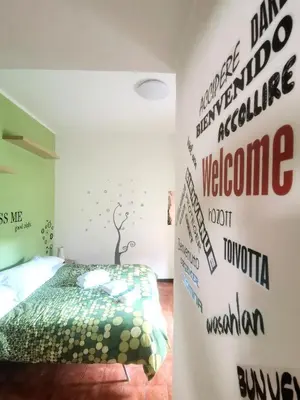 a bedroom with a bed and a wall with signs at My Vatican House in Rome