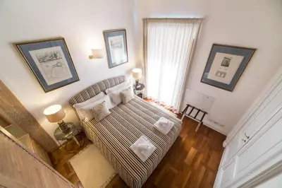 a living room with a couch and a window at Babuino 79 in Rome