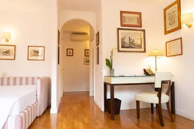 a bedroom with a desk and a bed and a table at Babuino 79 in Rome