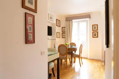 a dining room with a table and chairs at Babuino 79 in Rome