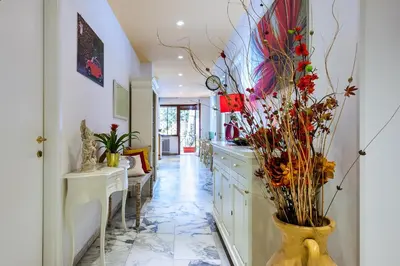 a kitchen with a vase with flowers in it at L'Oasi Verde a San Pietro apartment in Rome