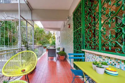 a patio with a yellow table and chairs on a balcony at L'Oasi Verde a San Pietro apartment in Rome