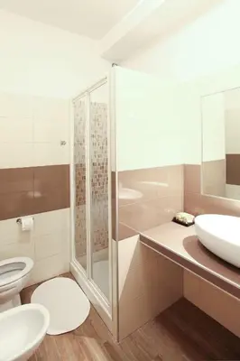 a bathroom with a shower and a sink and a toilet at L'Oasi Verde a San Pietro apartment in Rome