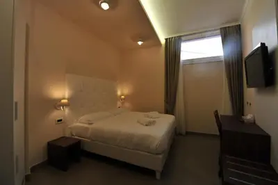 a bedroom with a bed and a window and a television at Villa Zaccardi in Rome