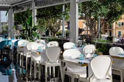 a row of white tables and chairs at a restaurant at Villa Zaccardi in Rome