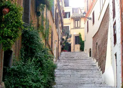 an alley with a stone path between two buildings at SuityRHome RioneMonti56 in Rome