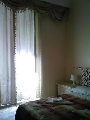 a bedroom with a bed and a large window at Roma Prince Inn accommodation in Rome