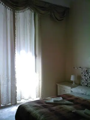 a bedroom with a bed and a large window at Roma Prince Inn accommodation in Rome