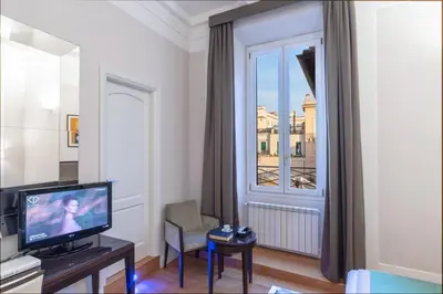 a living room with a television and a window at Internazionale Domus in Rome