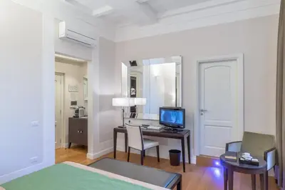 a bedroom with a desk with a computer and a mirror at Internazionale Domus in Rome