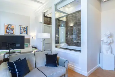 a living room with a couch and a large window at Internazionale Domus in Rome