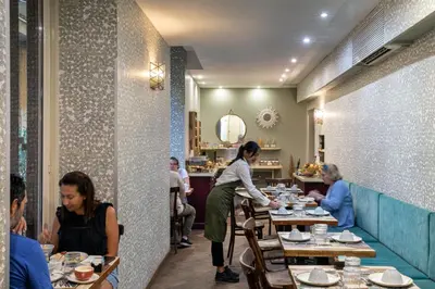 a group of people sitting at tables in a restaurant at Boutique Hotel Galatea in Rome
