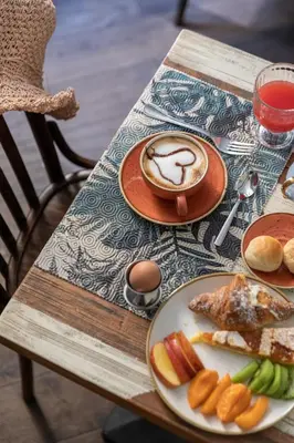 a table with plates of food and a cup of coffee at Boutique Hotel Galatea in Rome