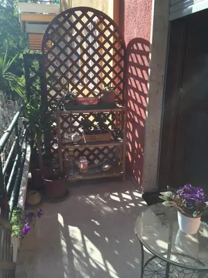 a patio with a chair and a glass table at Shelisa B&B in Rome