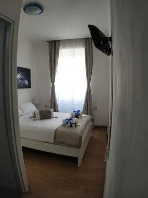 a bedroom with a bed and a large window at B&B Gaudium Colosseo in Rome