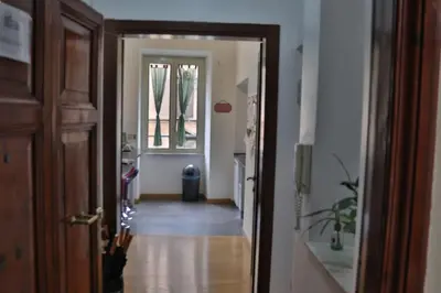 a hallway with a door leading to a room at B&B Gaudium Colosseo in Rome