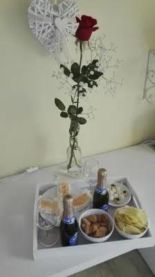 a tray of food with a rose in a vase at Gaia's Room B&B in Rome