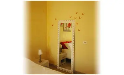 a mirror in the corner of a bedroom with a bed at Gaia's Room B&B in Rome