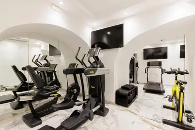 a gym with treadmills ellipticals and exercise bikes at Romanico Palace Luxury Hotel & SPA in Rome
