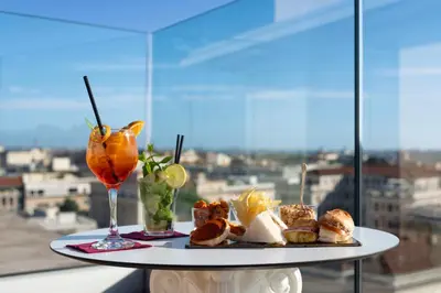 a table with a plate of food and a drink at Romanico Palace Luxury Hotel & SPA in Rome