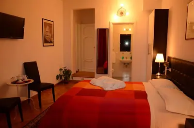 a hotel room with a bed with a red blanket at Vatican Dream in Rome