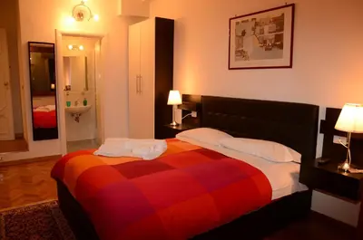 a bedroom with a bed with a colorful blanket at Vatican Dream in Rome