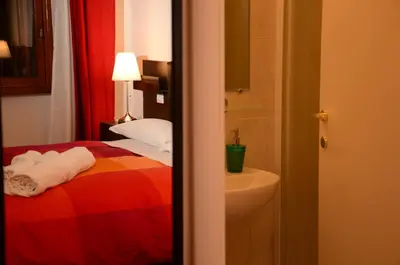a hotel room with a bed and a sink at Vatican Dream in Rome