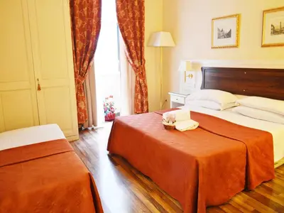 a hotel room with a large bed and a window at Residenza Domiziano in Rome