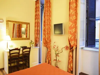 a room with a table and chairs and a mirror at Residenza Domiziano in Rome