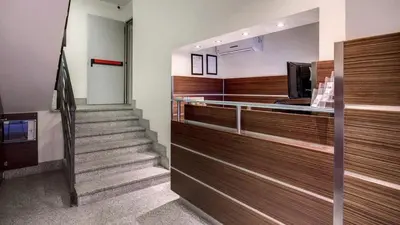 a lobby with a staircase in a building at The Strand Hotel in Rome