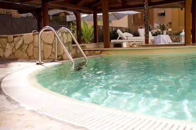 a swimming pool with a water slide in it at The Strand Hotel in Rome