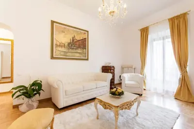 a living room with a white couch and a table at Suite Sarandrea in Rome