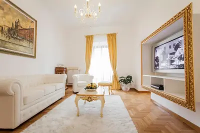 a living room with a white couch and a tv at Suite Sarandrea in Rome
