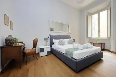a bedroom with a bed and a desk and a chair at 4BNB - Spacious Belli Apartment in Rome