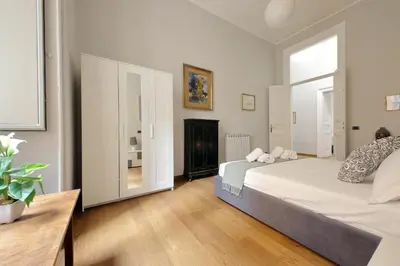 a bedroom with a large bed and a fireplace at 4BNB - Spacious Belli Apartment in Rome