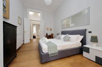a bedroom with a large bed with a large mirror at 4BNB - Spacious Belli Apartment in Rome