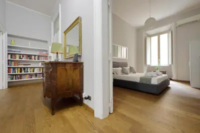 a bedroom with a bed and a mirror and a dresser at 4BNB - Spacious Belli Apartment in Rome