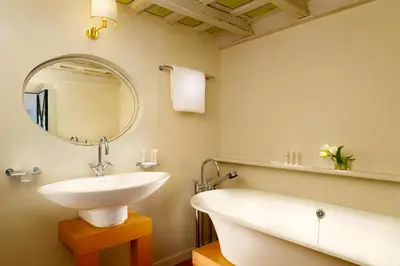a bathroom with a sink and a tub and a mirror at Splendor Suite Rome - Suites & Apartments in Rome