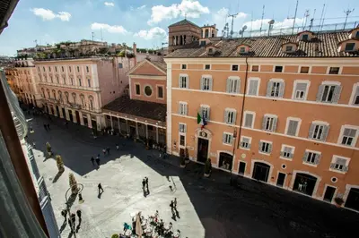 a group of people walking around a courtyard in a city at Splendor Suite Rome - Suites & Apartments in Rome