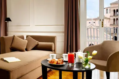 a living room with a couch and a table at Splendor Suite Rome - Suites & Apartments in Rome