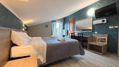 a bedroom with a bed and a table and a desk at Hotel Concorde in Rome