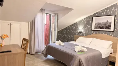 a hotel room with a bed and a desk and a table at Hotel Concorde in Rome