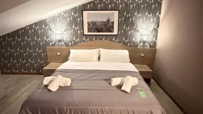 a bedroom with a large bed with two towels on it at Hotel Concorde in Rome